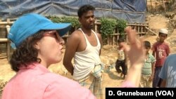 Marina Drazba, a disaster risk reduction specialist for the United Nations refugee agency (UNHCR), explains to Mohammed Zahed the steps he should take to prevent water from eroding away the hill where his family’s shelter sits.