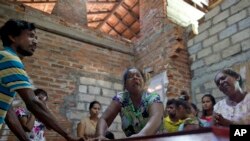 Lalitha, center, weeps beside the coffin with the remains of 12-year old niece, Sneha Savindi, who was a victim of Easter Sunday bombing at St. Sebastian Church, after it returning home in Negombo, Sri Lanka, April 22, 2019.