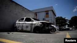 A burned car in which a body was found during searches for the Greek Ambassador for Brazil Kyriakos Amiridis, is pictured at a police station in Belford Roxo, Brazil Dec. 30, 2016.