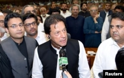 FILE - Imran Khan (C), chairman of Pakistan Tehreek-e-Insaf (PTI) political party speaks after he was elected as Prime Minister at the National Assembly (Lower House of Parliament) in Islamabad, Aug. 17, 2018.