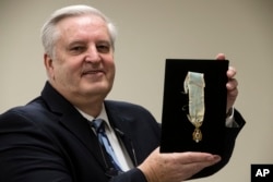 Displayed is Alexander Hamilton's Society of the Cincinnati Eagle insignia by Douglas Hamilton, his fifth great-grandson, at the Museum of the American Revolution in Philadelphia, Nov. 12, 2018.