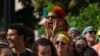 A rainbow wig-wearing fan cheers during the Capital Pride Parade in Washington, June 9, 2018. The yearly event is hosted by and in support of the the LGBTQ+ community and moves through the Dupont Circle and Logan Circle neighborhoods of Washington.