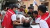 Seorang demonstran yang terluka dirawat oleh petugas medis di rumah sakit Latha, Yangon, Myanmar (27/3). 