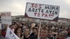 FILE - Protesters hold a placard that reads in Greek, "SOS Moria. Solution now," referring to the Moria refugee camp, during a protest in the town of Mytilene on the northeastern Aegean island of Lesbos, May 3, 2018. 