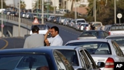 Drivers talk as they wait for fuel in a queue stretching for some hundreds of meters, in central Tripoli, Libya, (File)