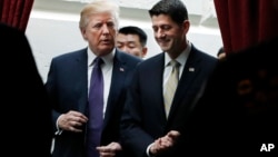 FILE - President Donald Trump, left, walks with House Speaker Paul Ryan of Wisconsin as they leave a meeting with House Republicans on Capitol Hill in Washington, Nov. 16, 2017.