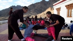 The nuns help participants stretch their muscles during a five-day workshop teaching young women the martial art of Kung Fu, in Hemis region in Ladakh, India, August 18, 2017.