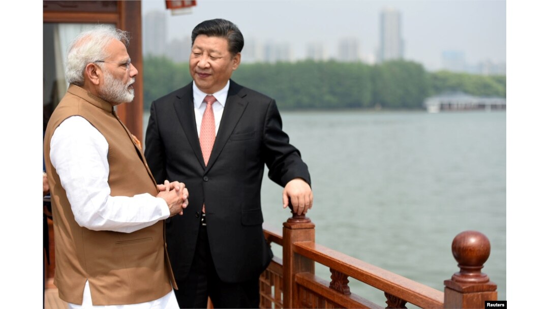 India's Prime Minister Narendra Modi speaks with Chinese President Xi Jinping as they take a boat ride on the East Lake in Wuhan, China, April 28, 2018.