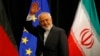 FILE - Iranian Foreign Minister Mohammad Javad Zarif waves after a plenary session at the United Nations building in Vienna.