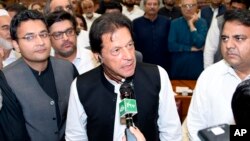 In this photo released by the National Assembly, the leader of Pakistan Tahreek-e-Insaf party Imran Khan, speaks at the National Assembly in Islamabad, Aug. 17, 2018. 