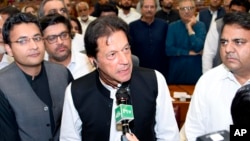 In this photo released by the National Assembly, the leader of Pakistan Tahreek-e-Insaf party Imran Khan,speaks at the National Assembly in Islamabad, Pakistan, Aug. 17, 2018.