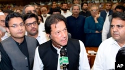 FILE - In this photo released by the National Assembly, the leader of Pakistan Tahreek-e-Insaf party Imran Khan,speaks at the National Assembly in Islamabad, Pakistan, Aug. 17, 2018. 