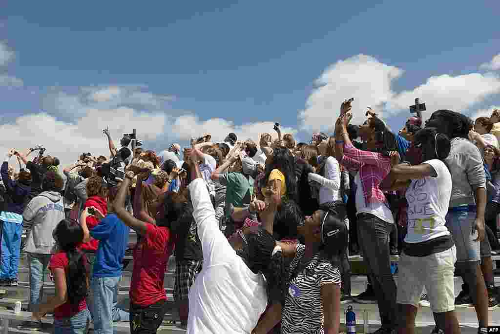 At NASA's Kennedy Space Center in Florida, about 50 students and other invited guests watch shuttle Discovery return from space for the last time, March 9, 2011. (NASA) 