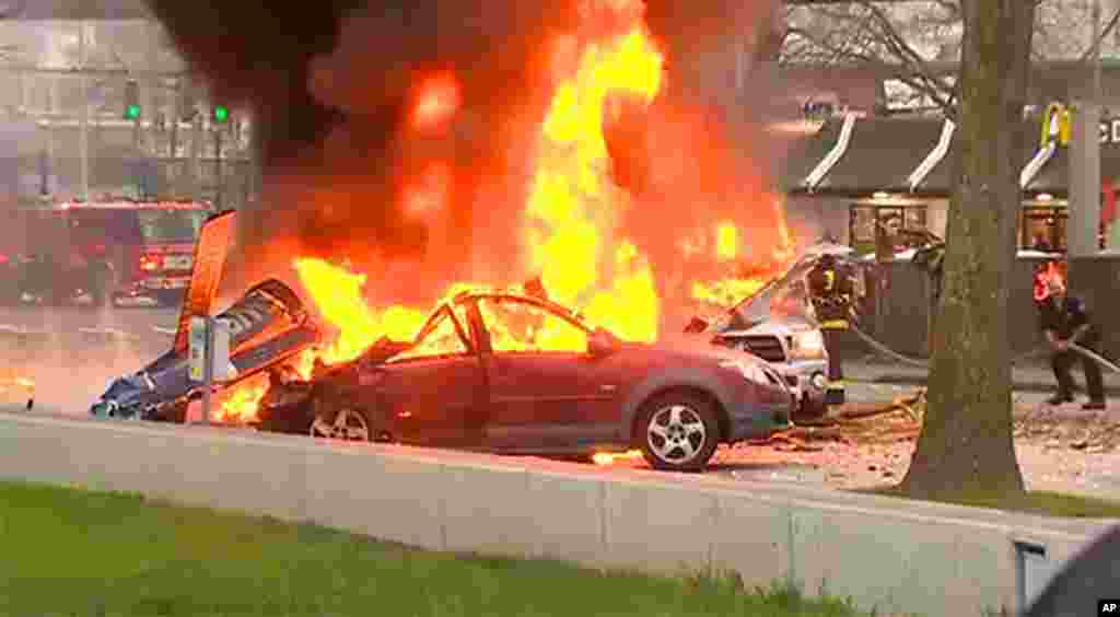 In this image made from video provided by KOMO-TV, smoke rises from the scene of a news helicopter crash outside the KOMO-TV studios near the space needle in Seattle, Washington. The station said the chopper was apparently coming in for a landing on its rooftop when it possibly hit the side of the building and went down, hitting several vehicles.