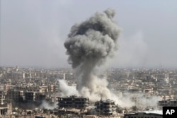 Smoke rises after shelling by the Syrian army, after Russian airstrikes, in Damascus, Syria, Oct. 14, 2015.