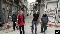 Syrian rebels stand in the Khalidiya district of the central Syrian city of Homs, May 3, 2012. 