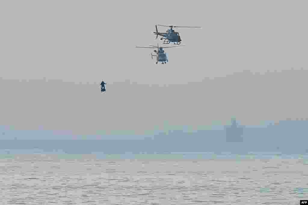 Franky Zapata on his jet-powered &quot;flyboard&quot; arrives at St. Margaret&#39;s Bay in Dover, England, during his attempt to fly across the 35-kilometer (22-mile) English Channel crossing in 20 minutes, with an average speed of 140 kilometers an hour (87 mph) at a height of 15-20 meters (50-65 feet) above the sea.