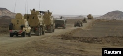 FILE - Egyptian Army vehicles are seen in the troubled northern part of the Sinai Peninsula during a launch of a major assault against militants, in Al Arish, Egypt, in this undated handout picture made available by the Ministry of Defense, March 4, 2018.