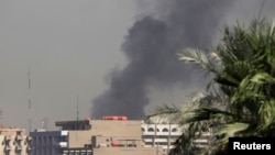 Smoke rises from the site of a bomb attack in central Baghdad, Sept. 18, 2013. 