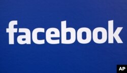 FILE - Facebook logo is displayed at a Facebook announcement in New York.