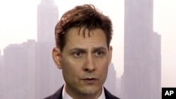 FILE -Image made from a video on March 28, 2018 shows Michael Kovrig, an adviser with the International Crisis Group, a Brussels-based non-governmental organization, speaking during an interview in Hong Kong. 