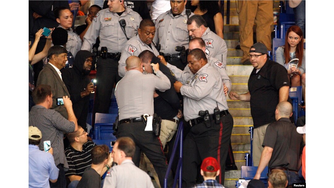 FILE - Police officers forcibly restrain a protester at U.S. Republican presidential candidate Donald Trump's campaign rally in Fayetteville, North Carolina, March 9, 2016.