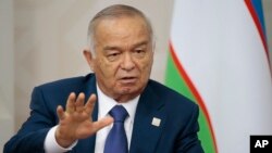 FILE - Uzbekistan's President Islam Karimov gestures while speaking to Russian President Vladimir Putin during the SCO (Shanghai Cooperation Organization) summit in Ufa, Russia, July 10, 2015.