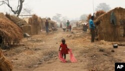 FILE - A child walks through a refugee camp in Kaga-Bandoro, Central African Republic, Feb. 16, 2016.