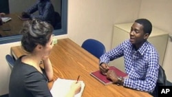 A young man at a University of Maryland speech clinic works with a therapist, April 2011