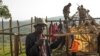 Evicted people build a house outside the protected Maasai Mau Forest in Kenya. Settlers in the forest say they paid for what they thought were legal titles to the land, but in many cases they were phony documents.