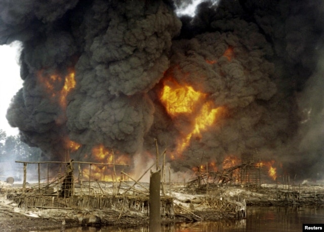 FILE - Smoke and flames billow from a burning oil pipeline in Andoni, Rivers State, Nigeria, Dec. 20, 2005.