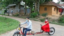 An engineer rides his specially-designed bicycle near Agartala, India with his daughter.
