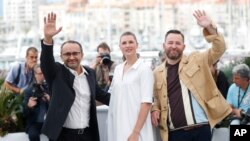 From left, director Andrey Zvyagintsev, actors Maryana Spikav and Alexei Rozin pose for photographers during the photo call for the film Loveless at the 70th international film festival, Cannes, southern France, Thursday, May 18, 2017. 
