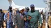 FILE - South Sudan's Oil minister Ezekiel Lul Gatkuoth (R) and Sudan's oil minister, Azhari Abdel Qader arrive for a ceremony marking the restarting of crude oil pumping at the Unity oil fields in South Sudan, Jan. 21, 2019. 