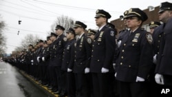 Police officers line the streets before the funeral of Officer Wenjian Liu in the Brooklyn borough of New York, Jan. 4, 2015. 