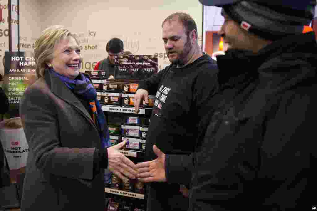 Democratic presidential candidate Hillary Clinton meets with customers as she stops at Dunkin' Donuts during the first-in-the-nation presidential primary, Feb. 9, 2016, in Nashua, N.H.