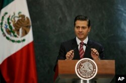 FILE - Mexico's President Enrique Pena Nieto speaks during a press conference at the Los Pinos presidential residence in Mexico City, Nov. 27, 2017.