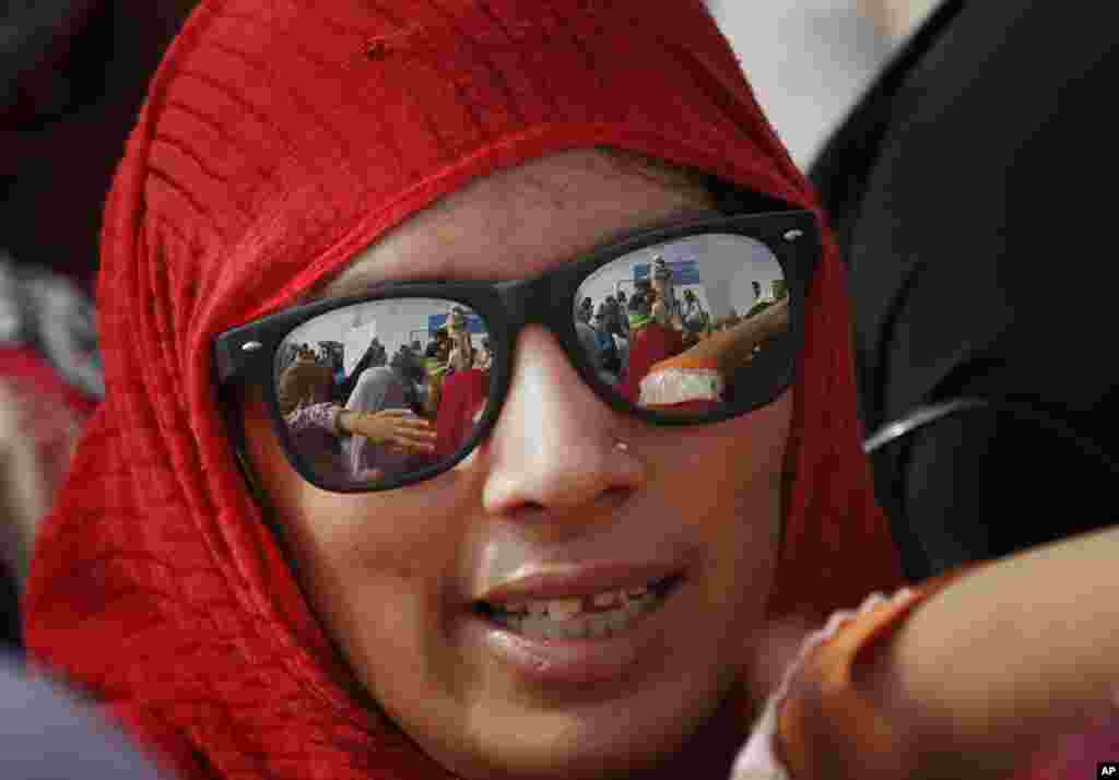 A supporter of cleric Tahir-ul-Qadri waits at Benazir Bhutto International airport in Islamabad, June 23, 2014.