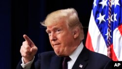 President Donald Trump acknowledges applause as speaks during a conference supporting veterans and military families through partnership at the Eisenhower Executive Office Building at the White House complex in Washington, Nov. 15, 2018. 