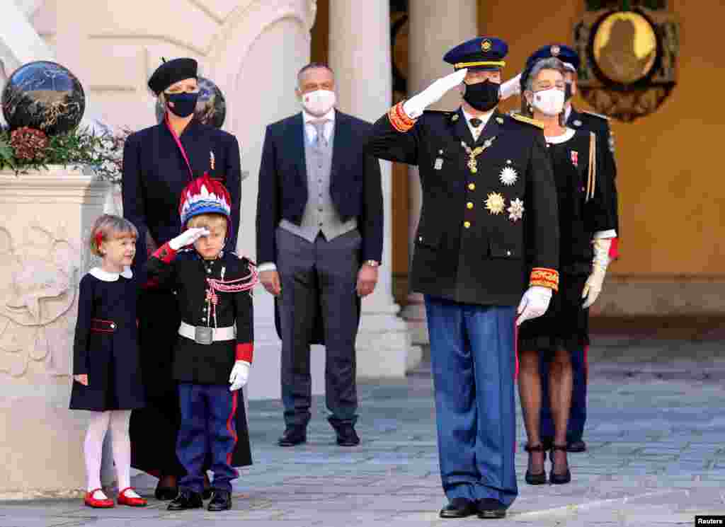 Prince Albert II and Prince Jacques salute as Princess Charlene and Princess Gabriella watch during celebrations marking Monaco&#39;s National Day at the Palace.