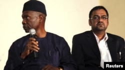 Francis Ogboro (L) and Suhail Farooqui, representatives of Dana Air, attend a news conference at Lagos State University Teaching Hospital, June 6, 2012. 