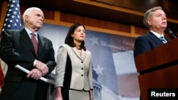 ຈາກຊ້າຍ, ສະມາຊິກສະພາສູງ ພັກຣີພັບບລີກັນ ທ່ານ John McCain ຈາກ Arizona, ທ່ານນາງ Kelly Ayotte ຈາກລັດ New Hampshire ແລະ ທ່ານ Lindsey Graham ຈາກລັດ South Carolina ກ່າວຖະແຫຼງຕໍ່ບັນດານັກຂ່າວໃນລັດຖະສະພາ Capitol Hill ກ່ຽວກັບການອອກກົດໝາຍເພັ່ງເລັງໃສ່ຂໍ້ຈຳກັດການນຳສົ່ງນັກໂທດຈາກ ອ່າວ Guantanamo, 13 ມັງກອນ, 2015.