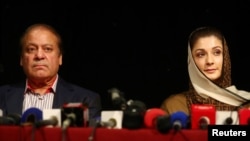 Ousted Pakistani prime minister Nawaz Sharif appears with his daughter Maryam at a news conference at a hotel in London, Britain, July 11, 2018. They are expected to return ot Pakistan Friday.
