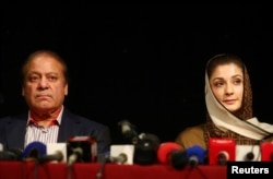 FILE - Ousted Pakistani prime minister Nawaz Sharif appears with his daughter Maryam at a news conference at a hotel in London, Britain, July 11, 2018.