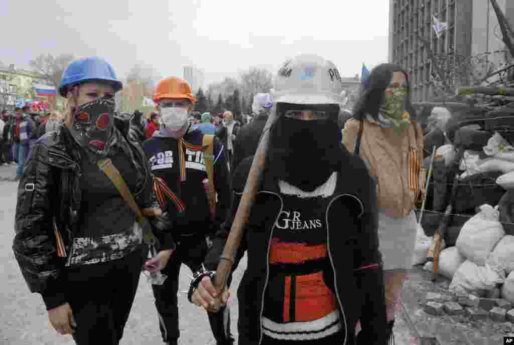 Masked pro-Russian activists guard barricades at the regional administration building in Donetsk, Ukraine, April 9, 2014.