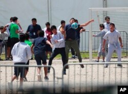 FILE - Migrant children play soccer at the Homestead Temporary Shelter for Unaccompanied Children in Homestead, Fla., April 19, 2019.