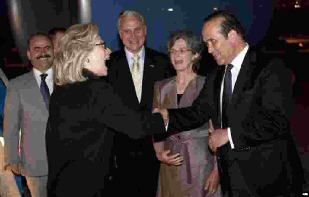 U.S. Secretary of State Hillary Rodham Clinton greets Turkish Ambassador to the U.S., Namik Tan, right, alongside U.S. Ambassador to Turkey Francis Ricciardone, center, and his wife, Marie Ricciardone, after disembarking from her airplane upon arrival in 