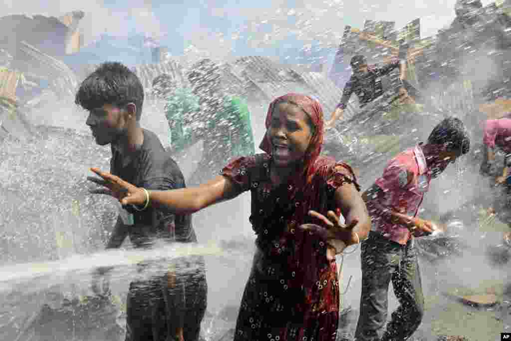 A Bangladeshi woman cries at the scene of a fire at a slum in Dhaka, Bangladesh.