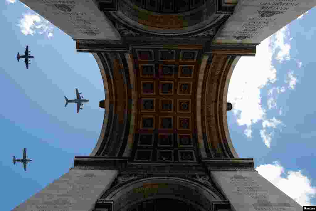 Military aircrafts fly over the Arc de Triomphe during a rehearsal for the Bastille Day celebrations in Paris, France.