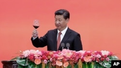 FILE - Chinese President Xi Jinping offers a toast after delivering a speech during a reception to mark the 70th anniversary of Japan's surrender during World War II in Beijing.